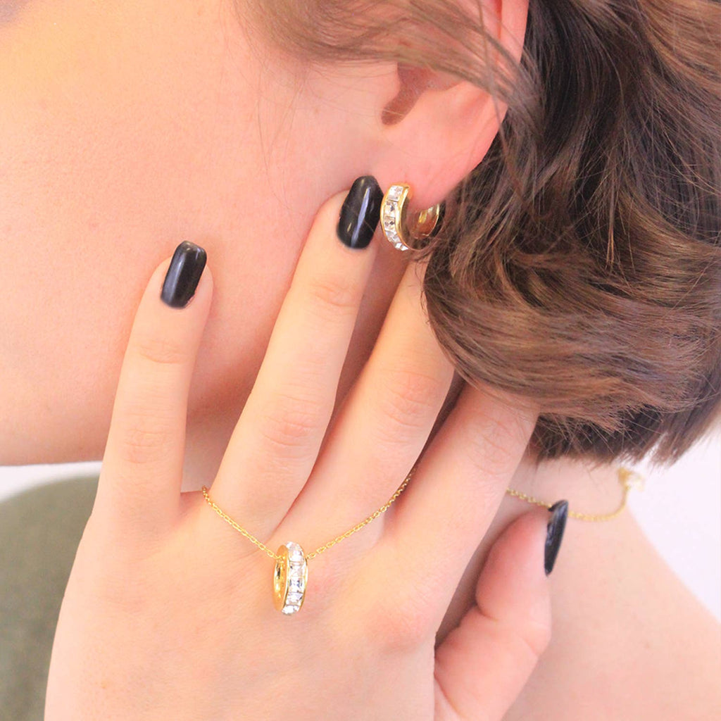Gold crystal square hoop earrings angled view