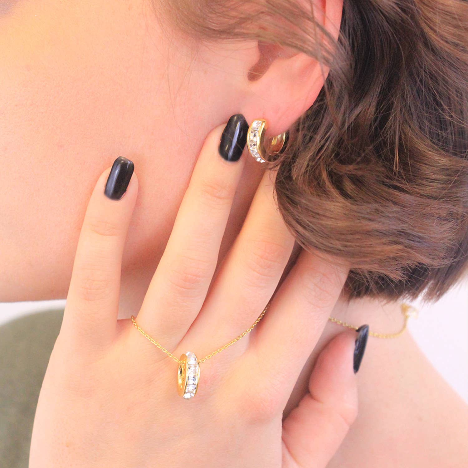 Gold crystal square hoop earrings angled view