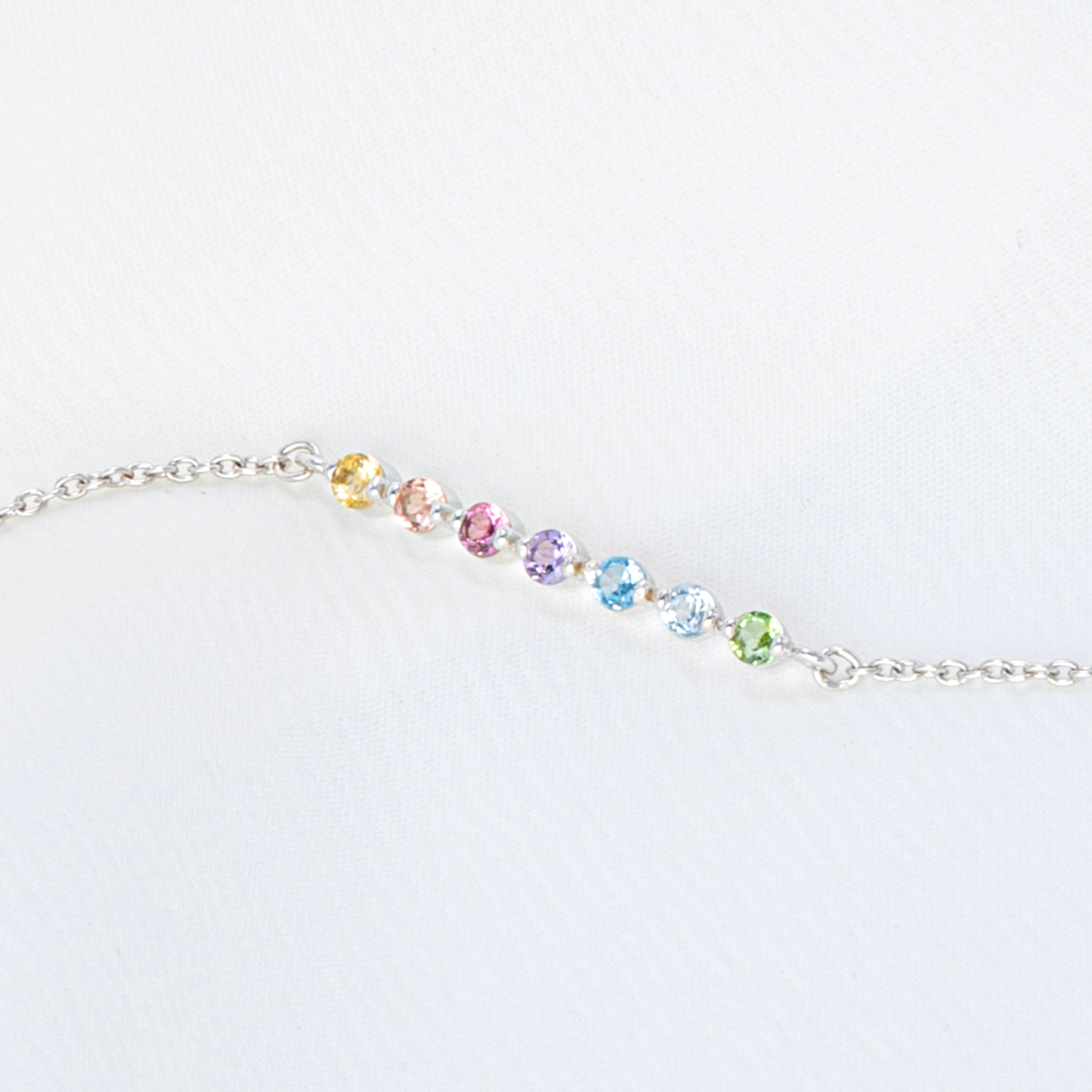Pastel rainbow gemstone bracelet in sterling silver on white background detail
