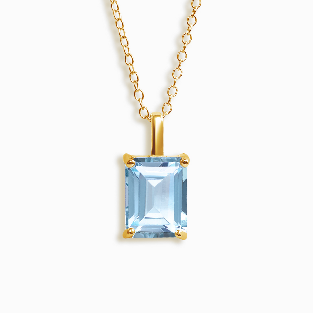 Blue topaz emerald cut pendant necklace in 18k gold vermeil on white background