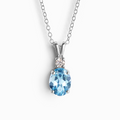 Blue topaz pendant necklace in sterling silver on white background