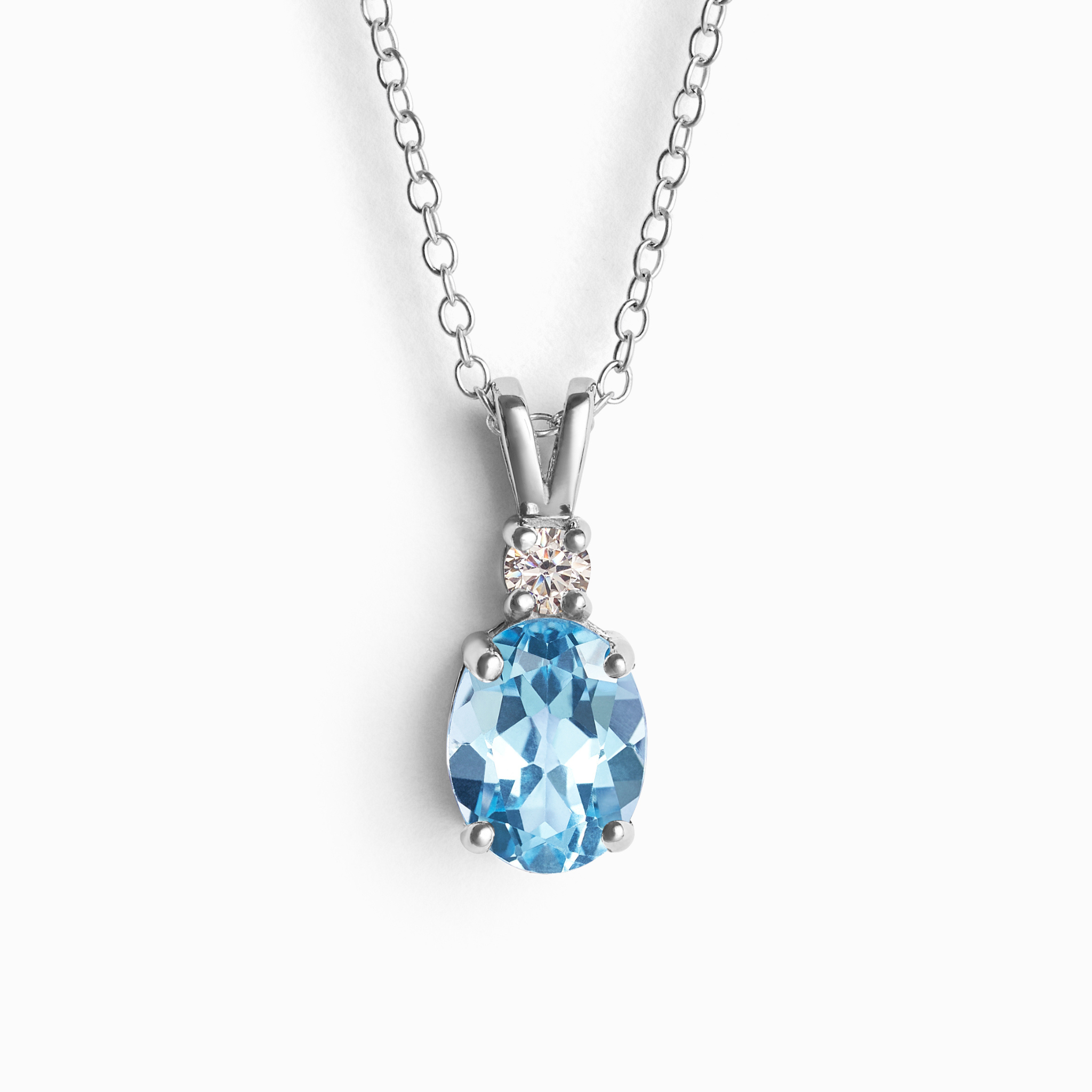 Blue topaz pendant necklace in sterling silver on white background