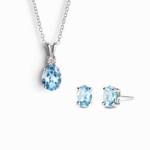 Blue topaz jewellery set with necklace and earrings in sterling silver on white background