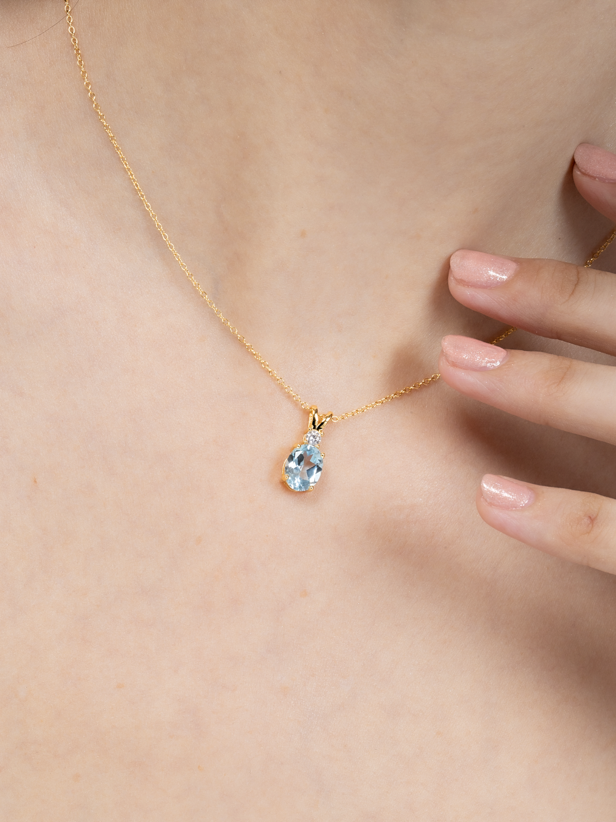 Blue topaz pendant necklace in 18k gold vermeil on neck