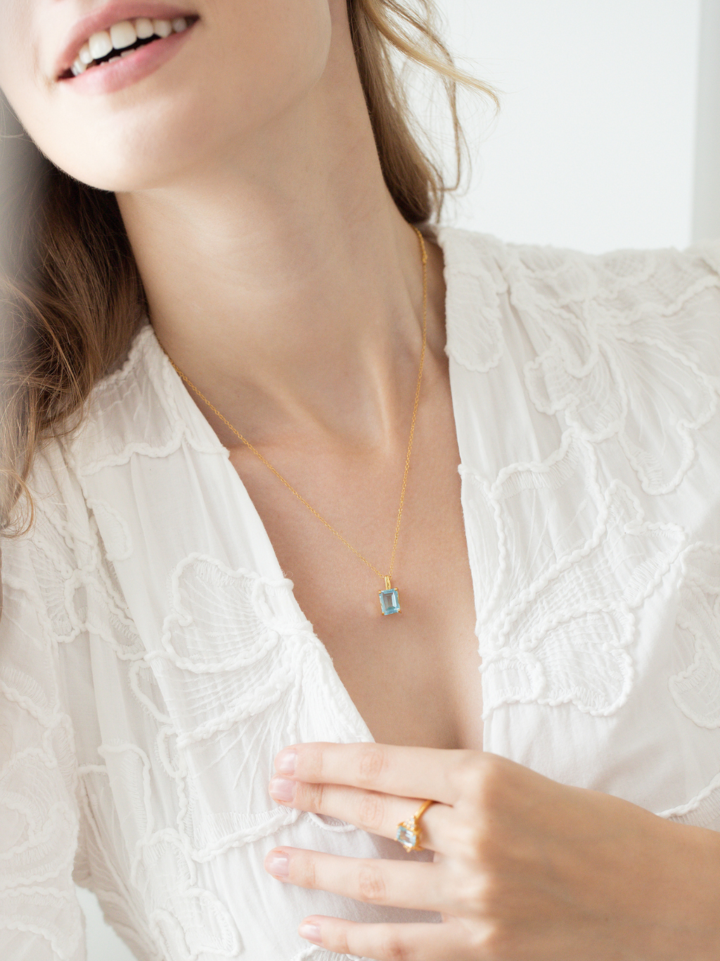 Blue topaz emerald cut pendant necklace in 18k gold vermeil on model