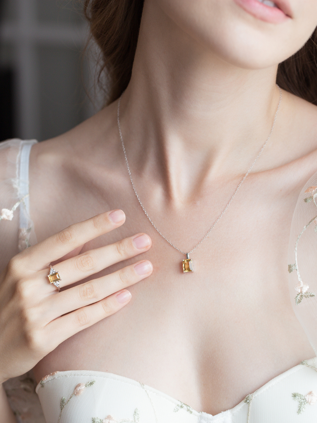 Citrine emerald cut ring and necklace in sterling silver on model