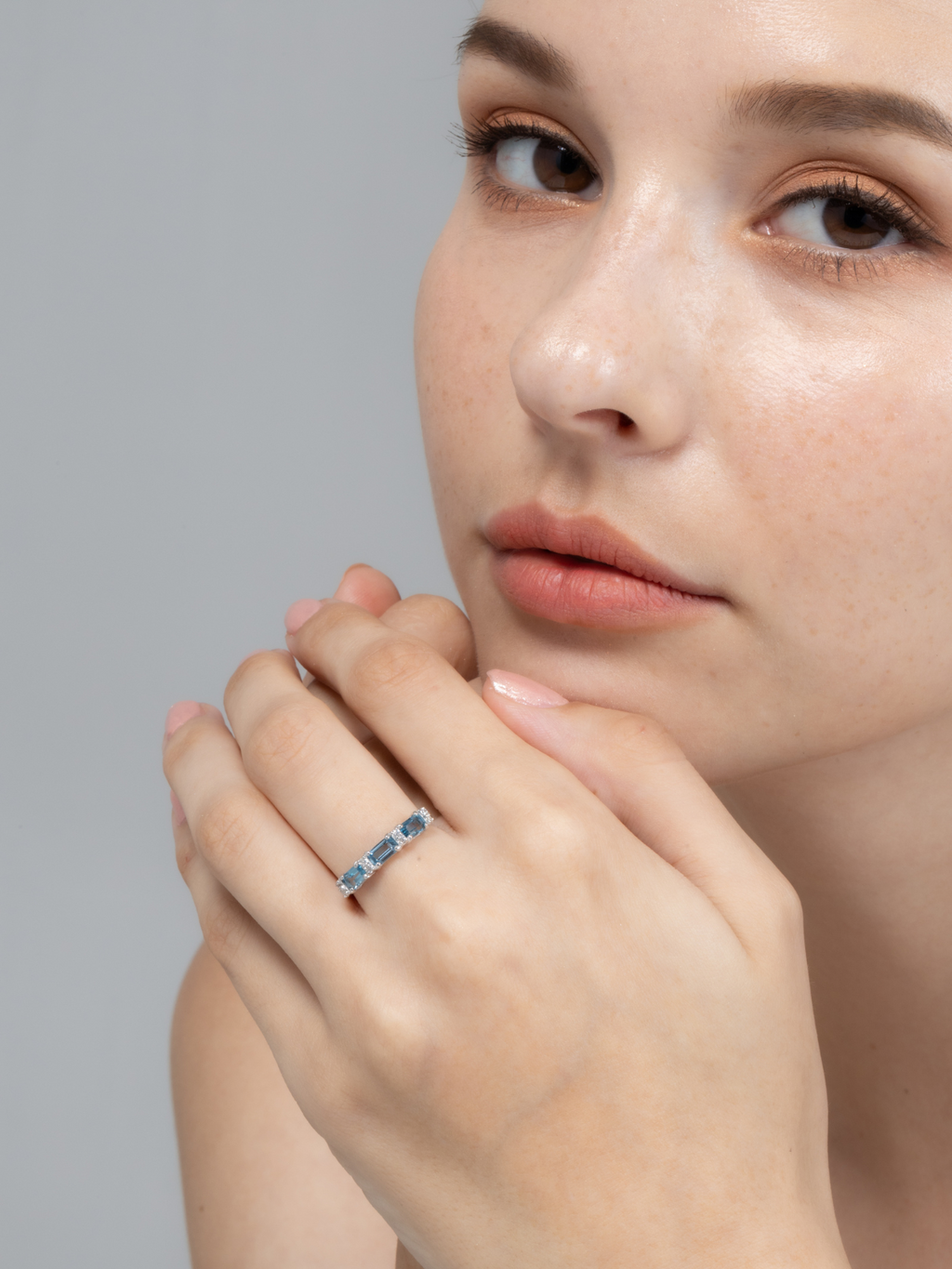 London blue topaz emerald cut eternity band in sterling silver on hand
