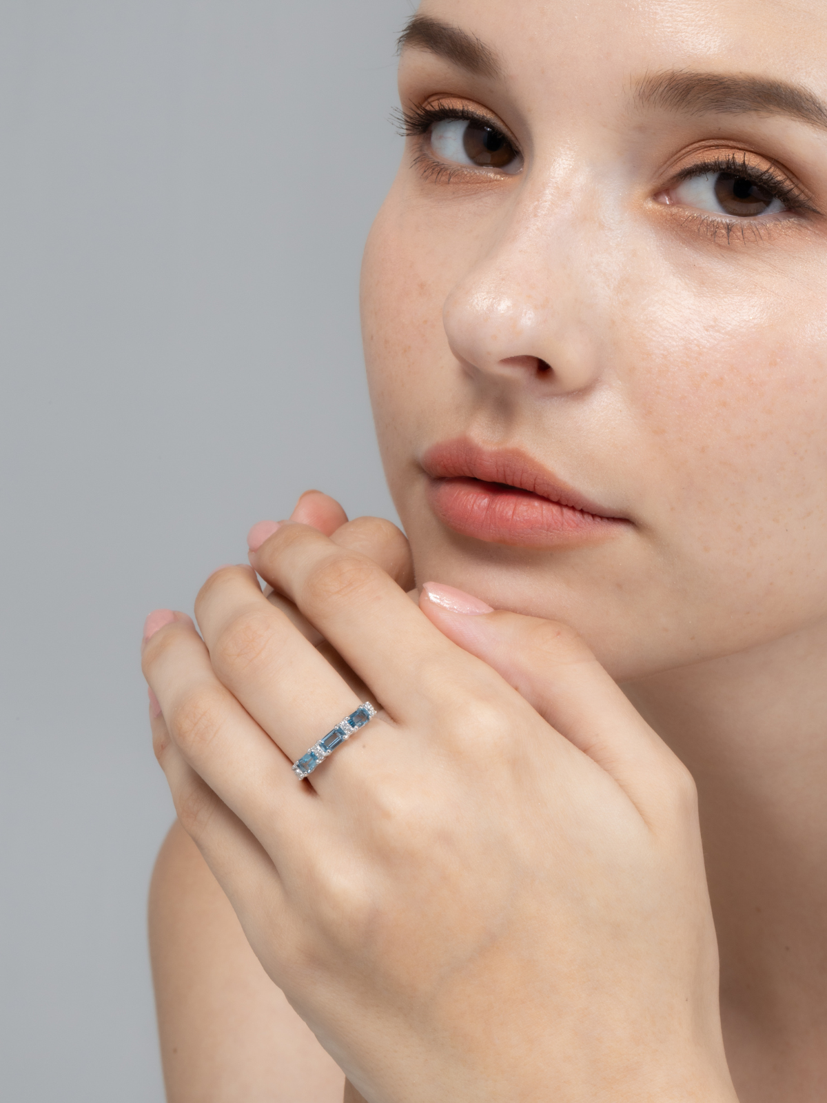 London blue topaz emerald cut eternity band in sterling silver on hand