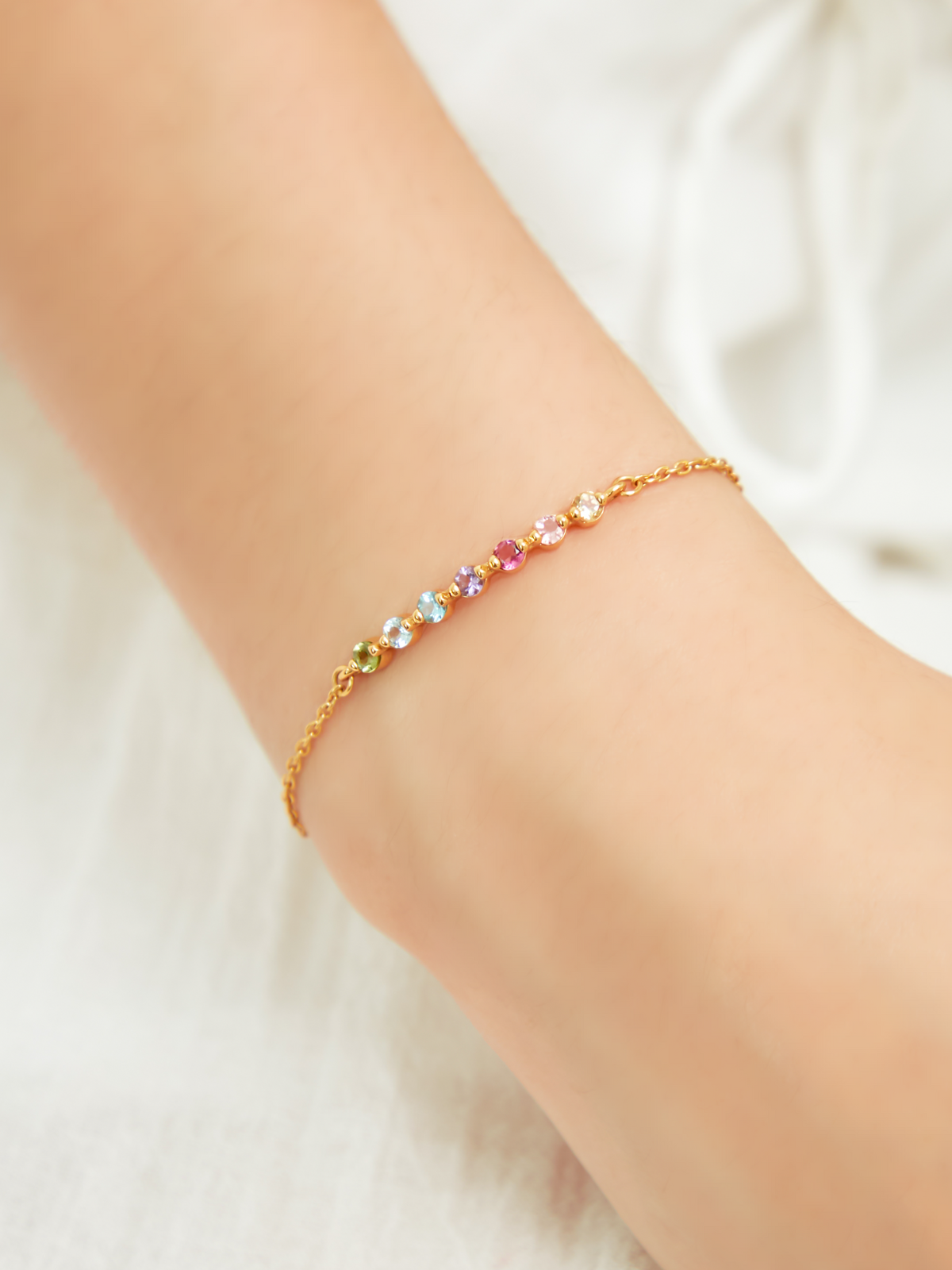 Pastel rainbow gemstone bracelet in 18k gold vermeil on wrist