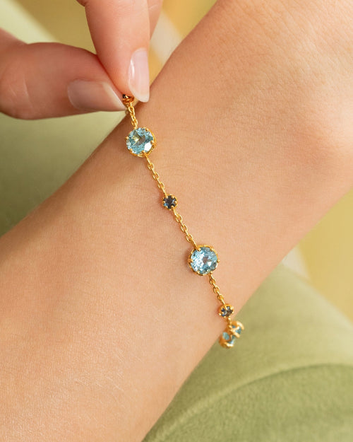 Vianne Jewellery blue sapphire and Swiss blue topaz tennis bracelet in 18k gold vermeil shown on model
