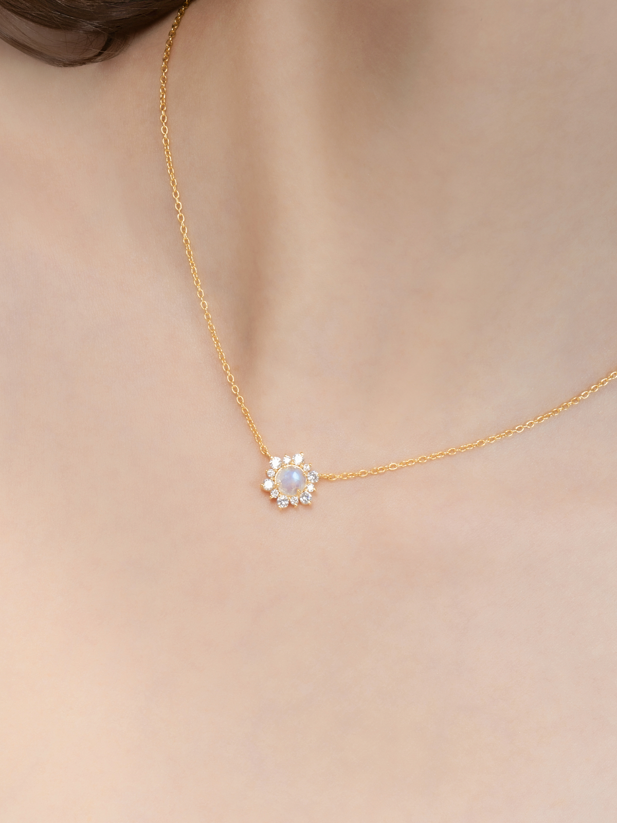 Model wearing rainbow moonstone necklace in 18k gold vermeil