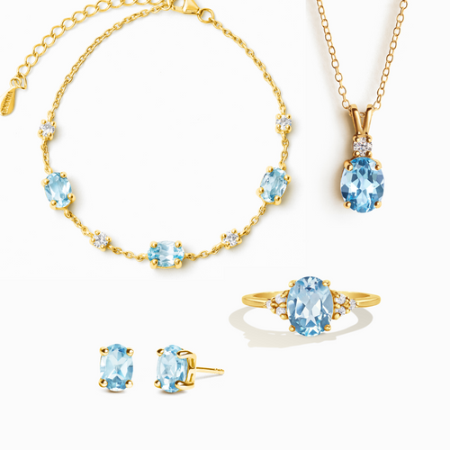Blue topaz complete jewellery set in 18k gold vermeil on white background