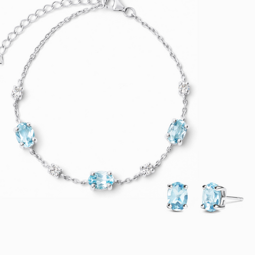 Blue topaz jewellery set with bracelet and earrings in sterling silver on white background