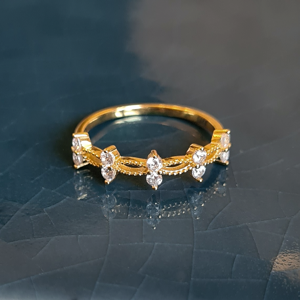 Alana gold ring on blue background