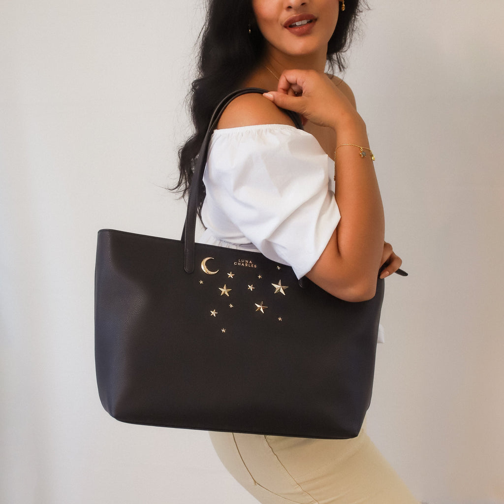 Luna Charles Anya black and gold star studded tote bag on model