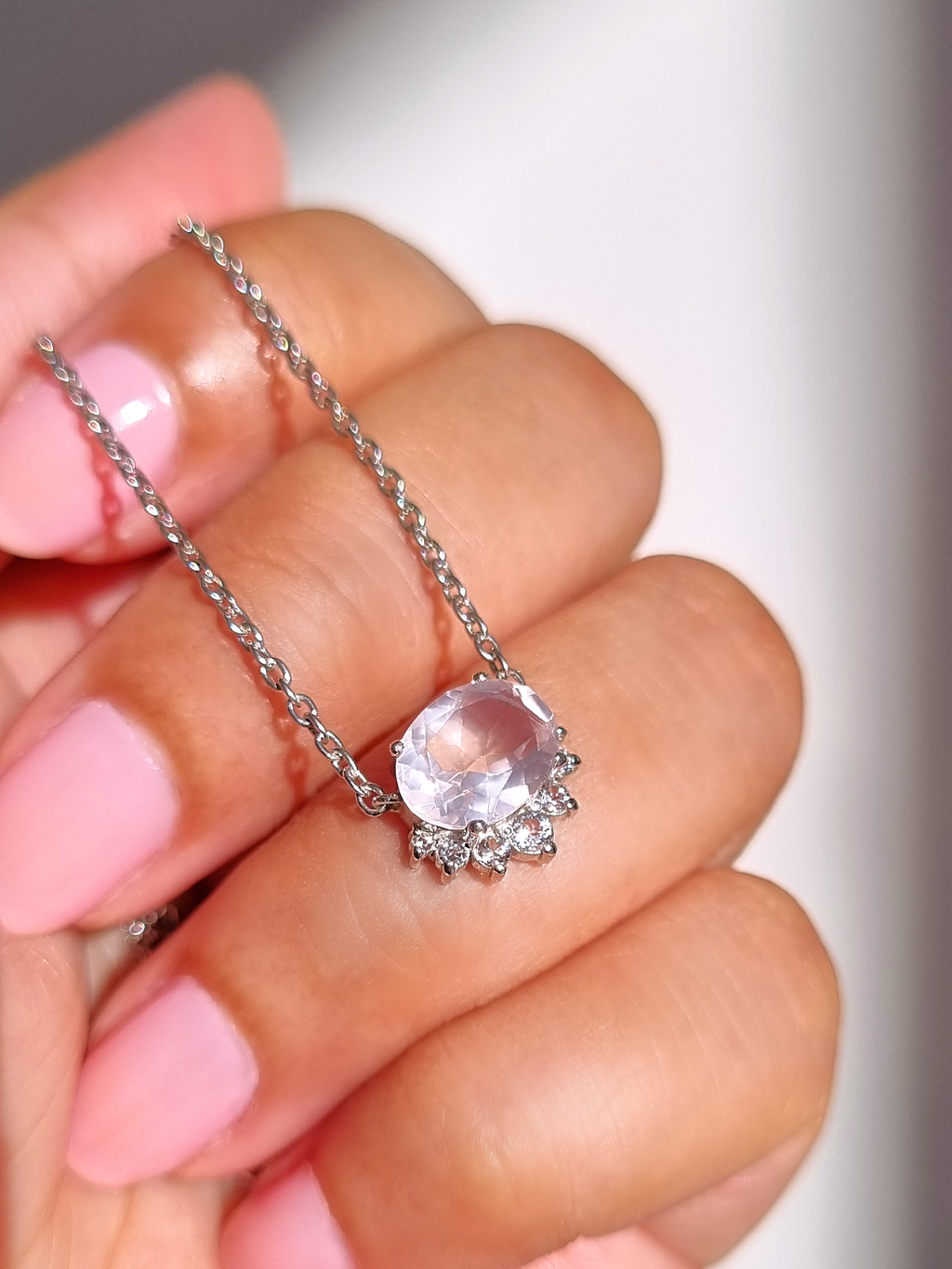 Aria rose quartz necklace in sterling silver on hand