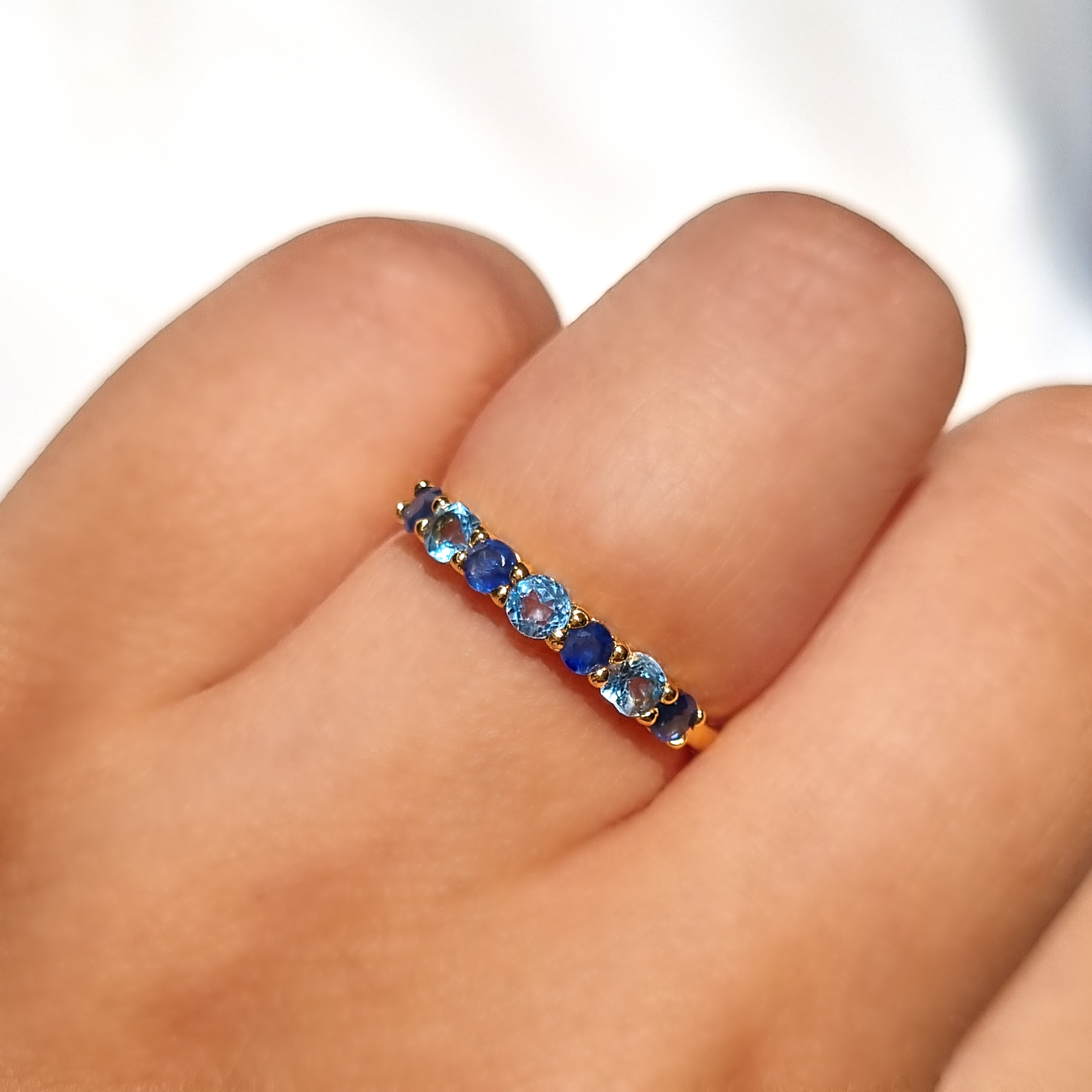 Blue sapphire and blue topaz half eternity band in 18k gold vermeil on hand
