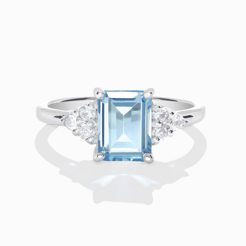 Blue topaz emerald cut ring in sterling silver on white background