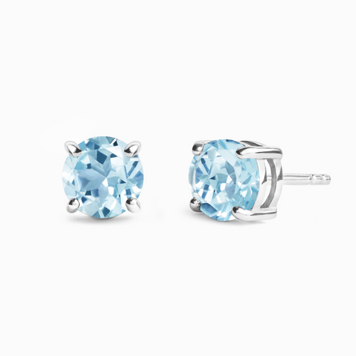 Blue topaz round stud earrings in sterling silver on white background