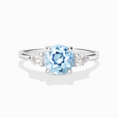 Blue topaz three stone ring in sterling silver on white background