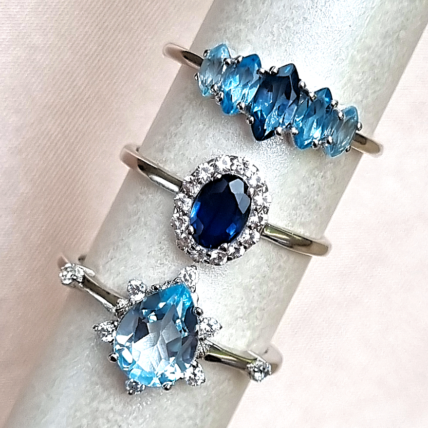 Blue gemstone rings group image with ombre blue topaz ring