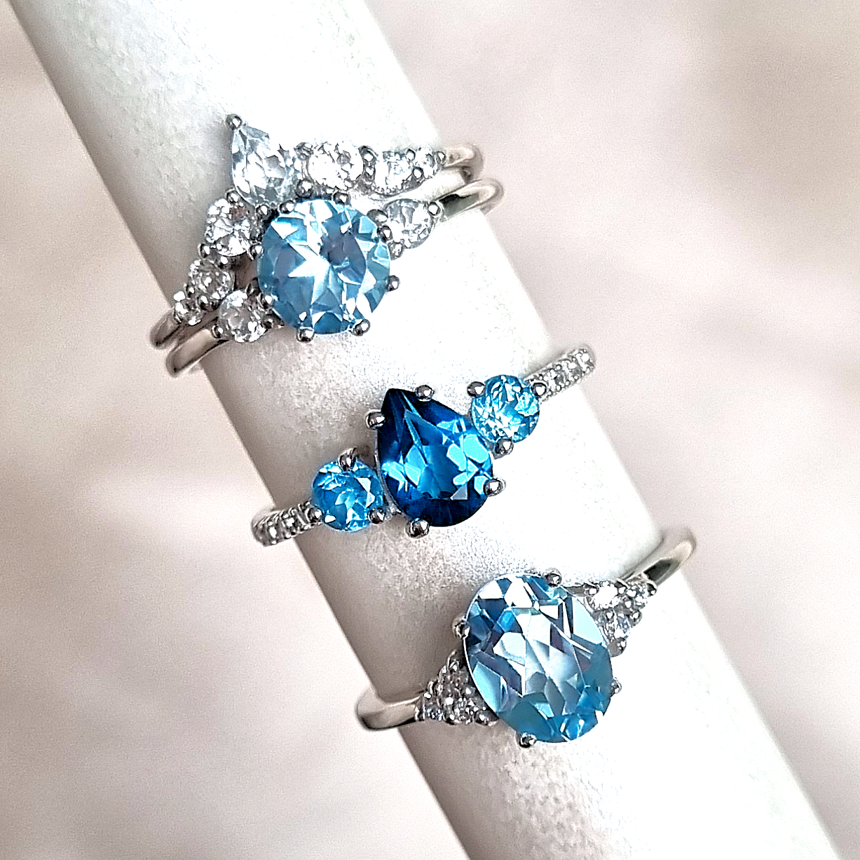 Blue topaz rings group image with London Swiss and sky blue topaz styles