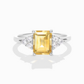Citrine emerald cut ring in sterling silver on white background