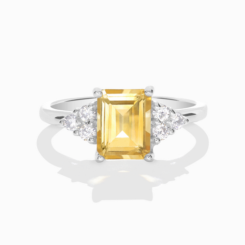 Citrine emerald cut ring in sterling silver on white background