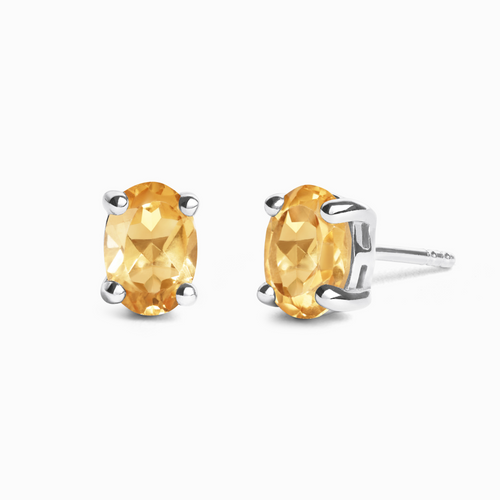 Citrine oval stud earrings in sterling silver on white background