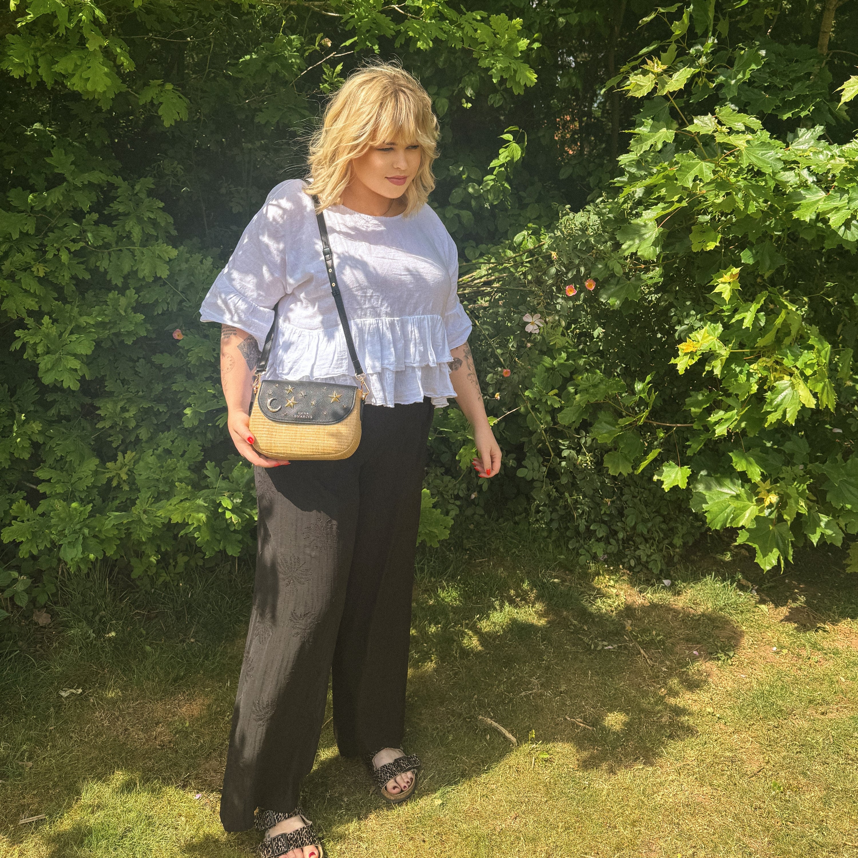 Luna Charles Elena black rattan handbag with gold star studs lifestyle image