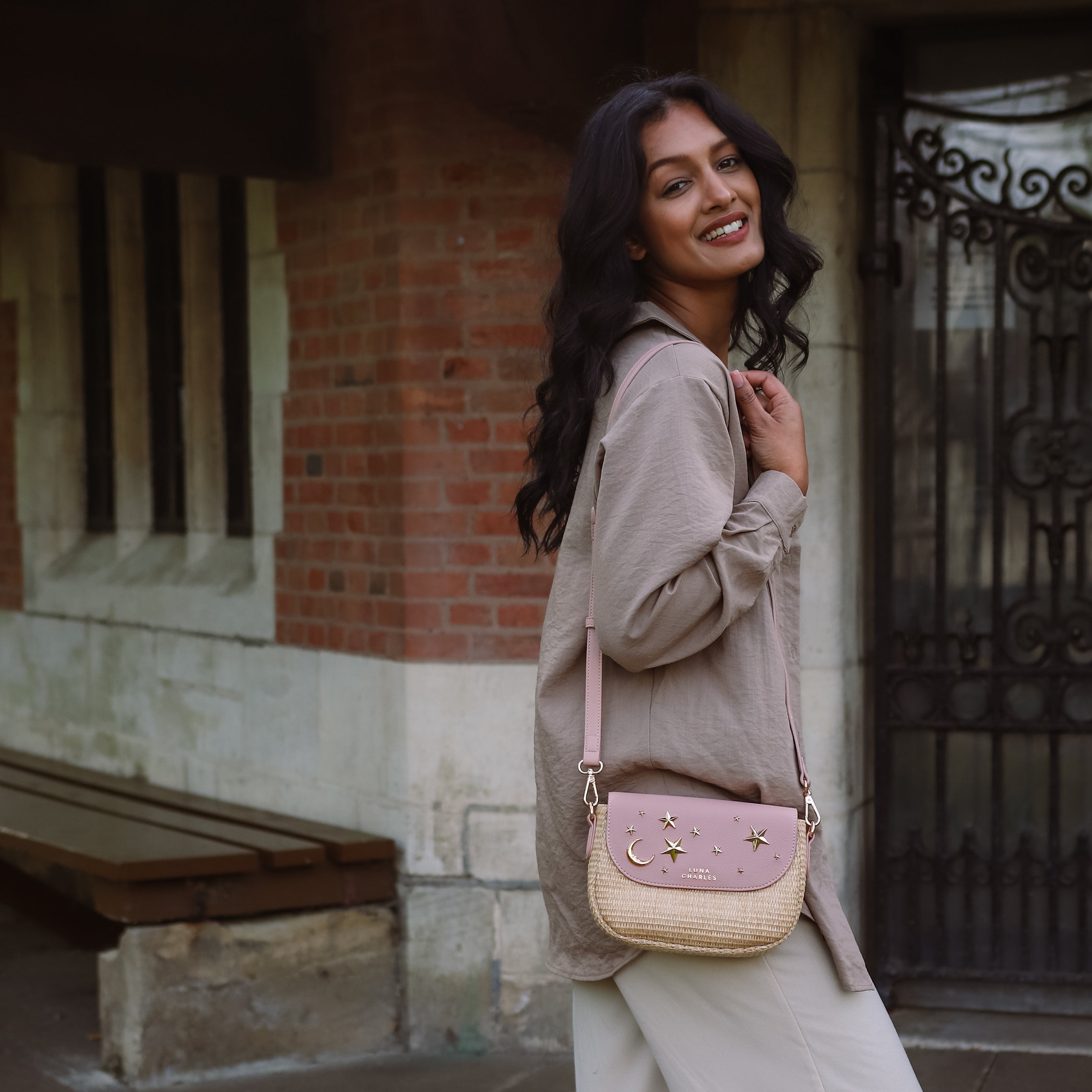 Luna Charles Elena pink rattan handbag close-up with gold star studs