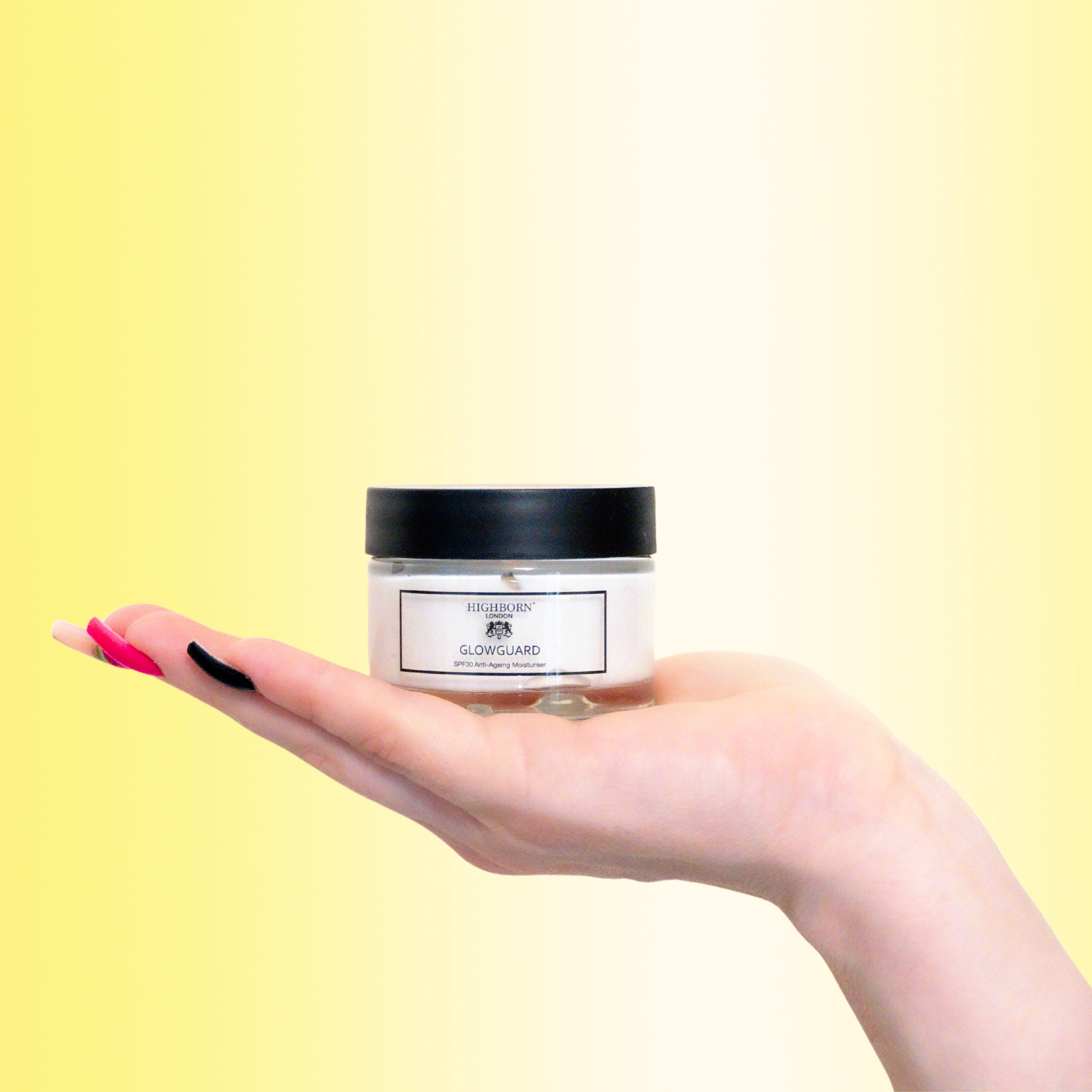 Highborn GLOWGUARD SPF30 moisturiser bottle in hand