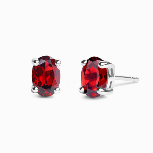 Garnet oval stud earrings in sterling silver on white background