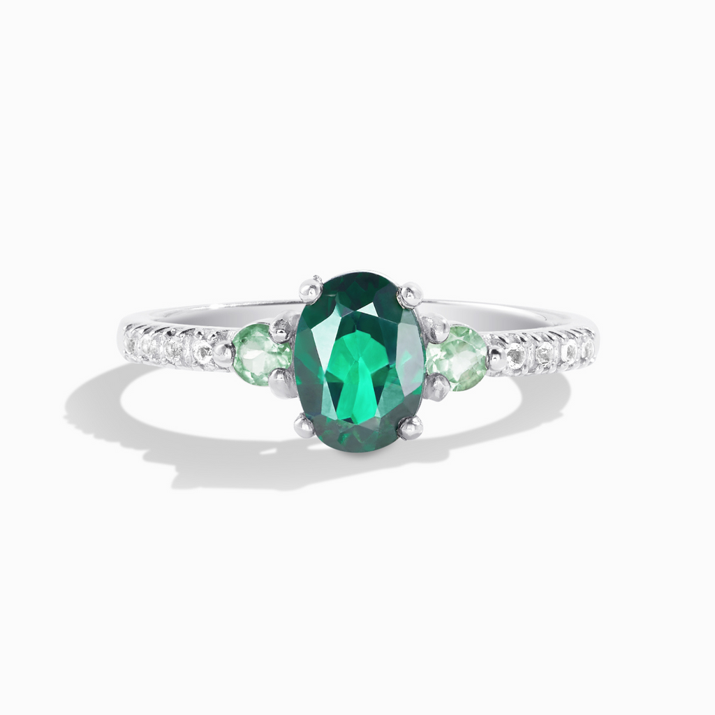 Green topaz and green tourmaline ring in sterling silver on white background