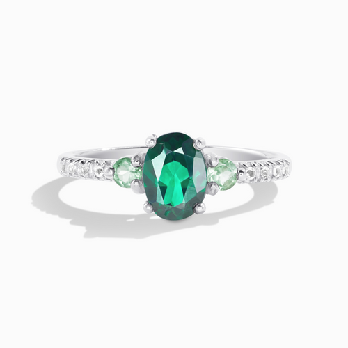 Green topaz and green tourmaline ring in sterling silver on white background