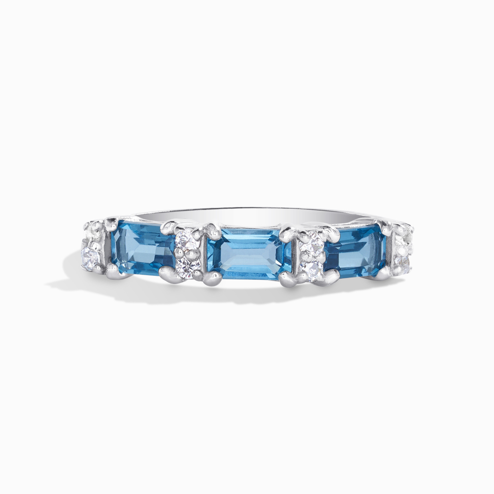 London blue topaz emerald cut eternity ring in sterling silver on white background