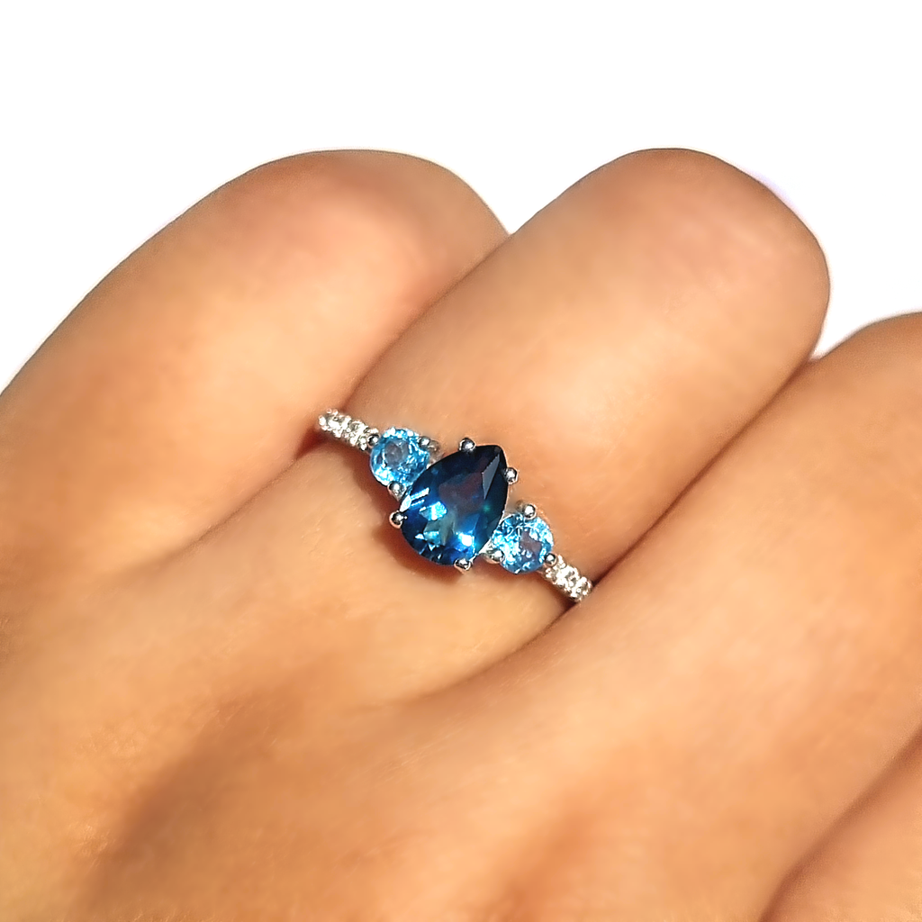 London blue and Swiss blue topaz pear cut ring in sterling silver on hand