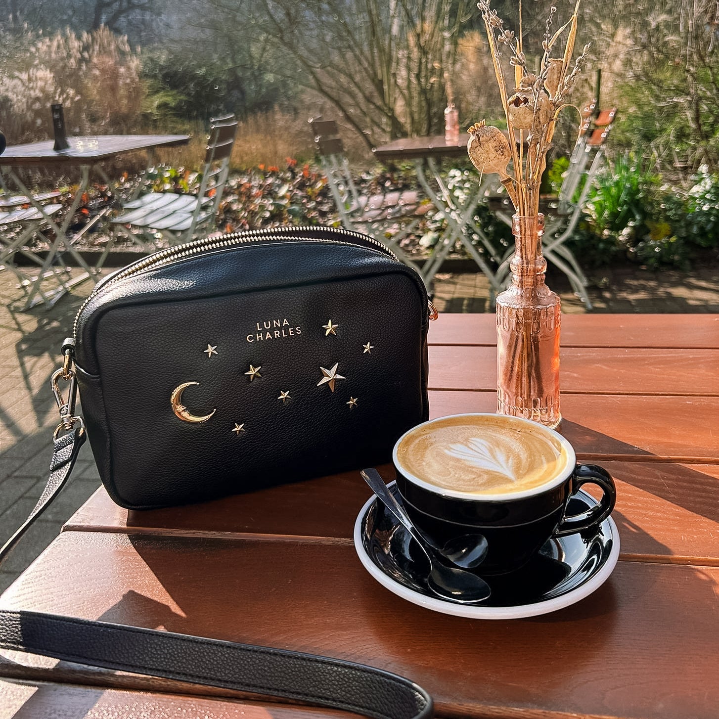 Luna Charles Maya black and gold crossbody bag styled with coffee