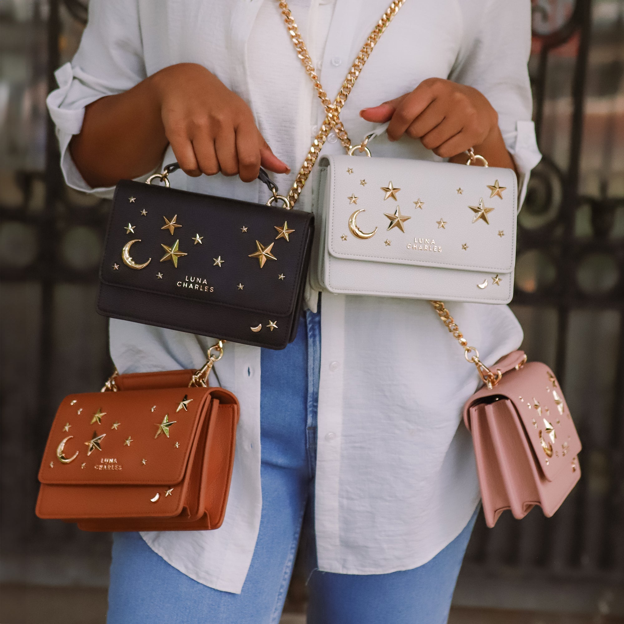 Luna Charles Nova black and gold star studded bag worn as crossbody