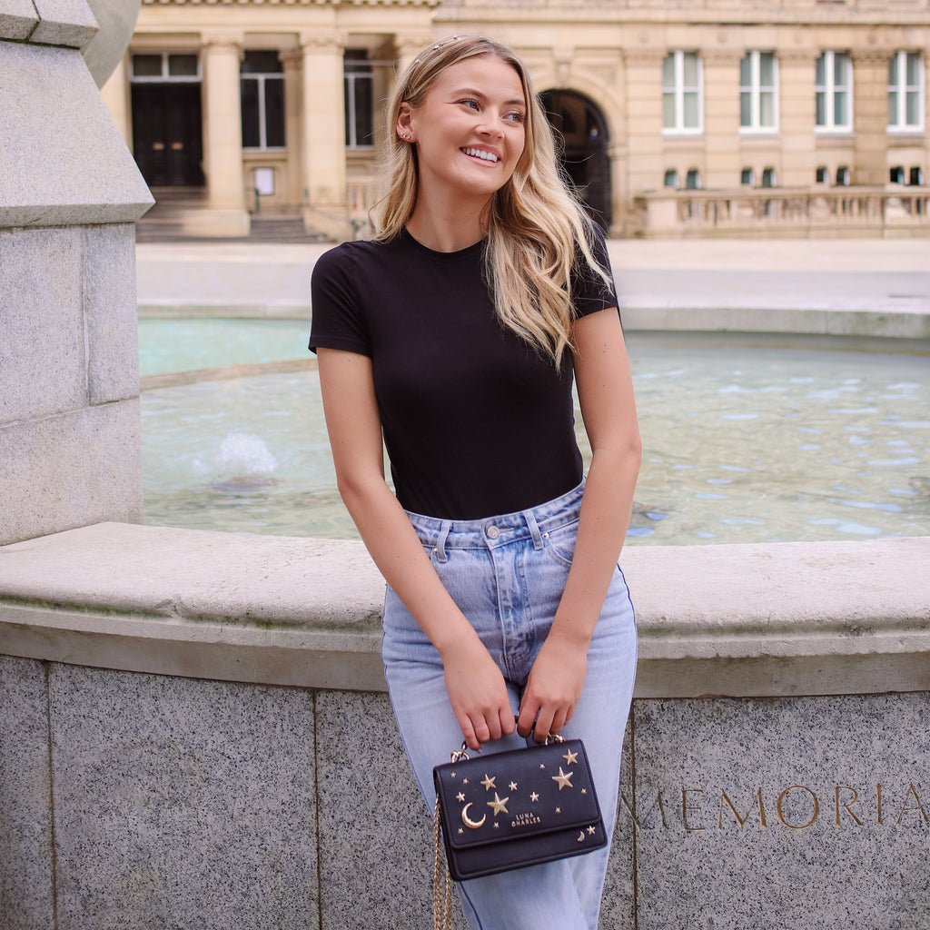 Luna Charles Nova black and gold crossbody bag styled with outfit