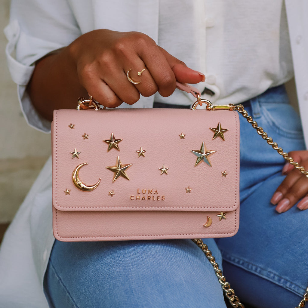 Luna Charles Nova pink and gold crossbody bag styled on model