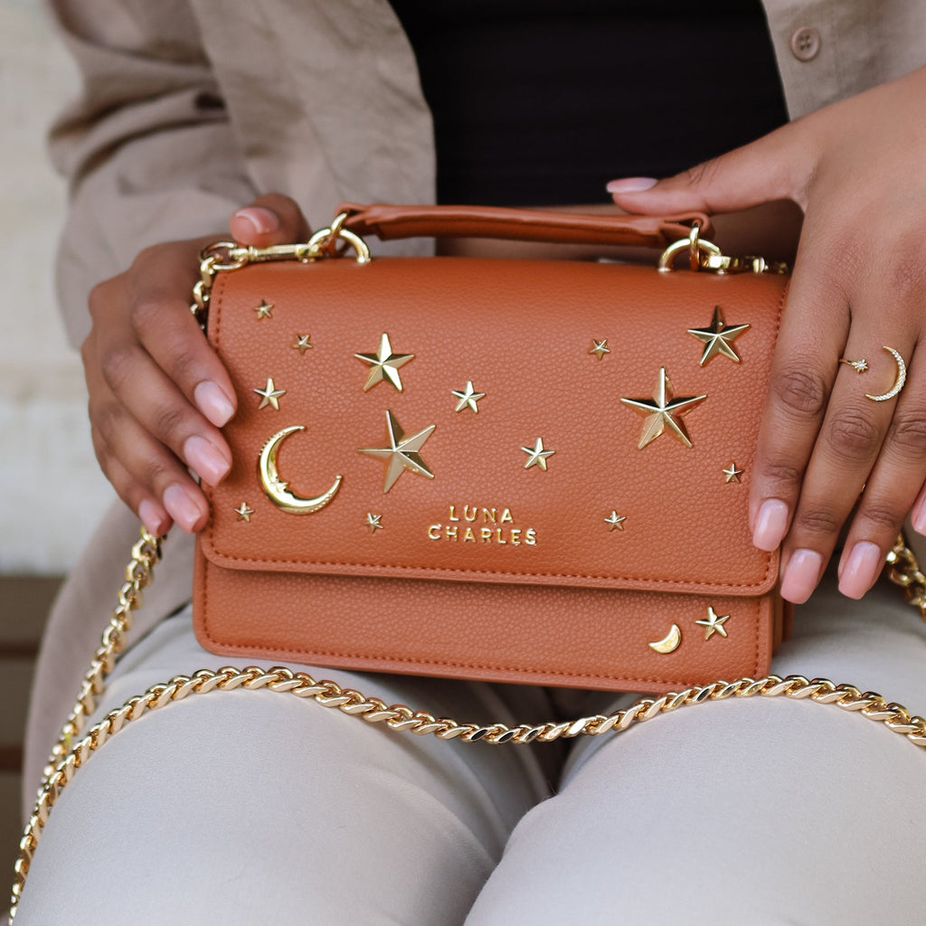 Luna Charles Nova tan and gold crossbody bag styled with pearl accessories
