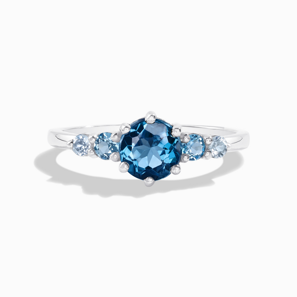 Ombre blue topaz five stone ring in sterling silver on white background