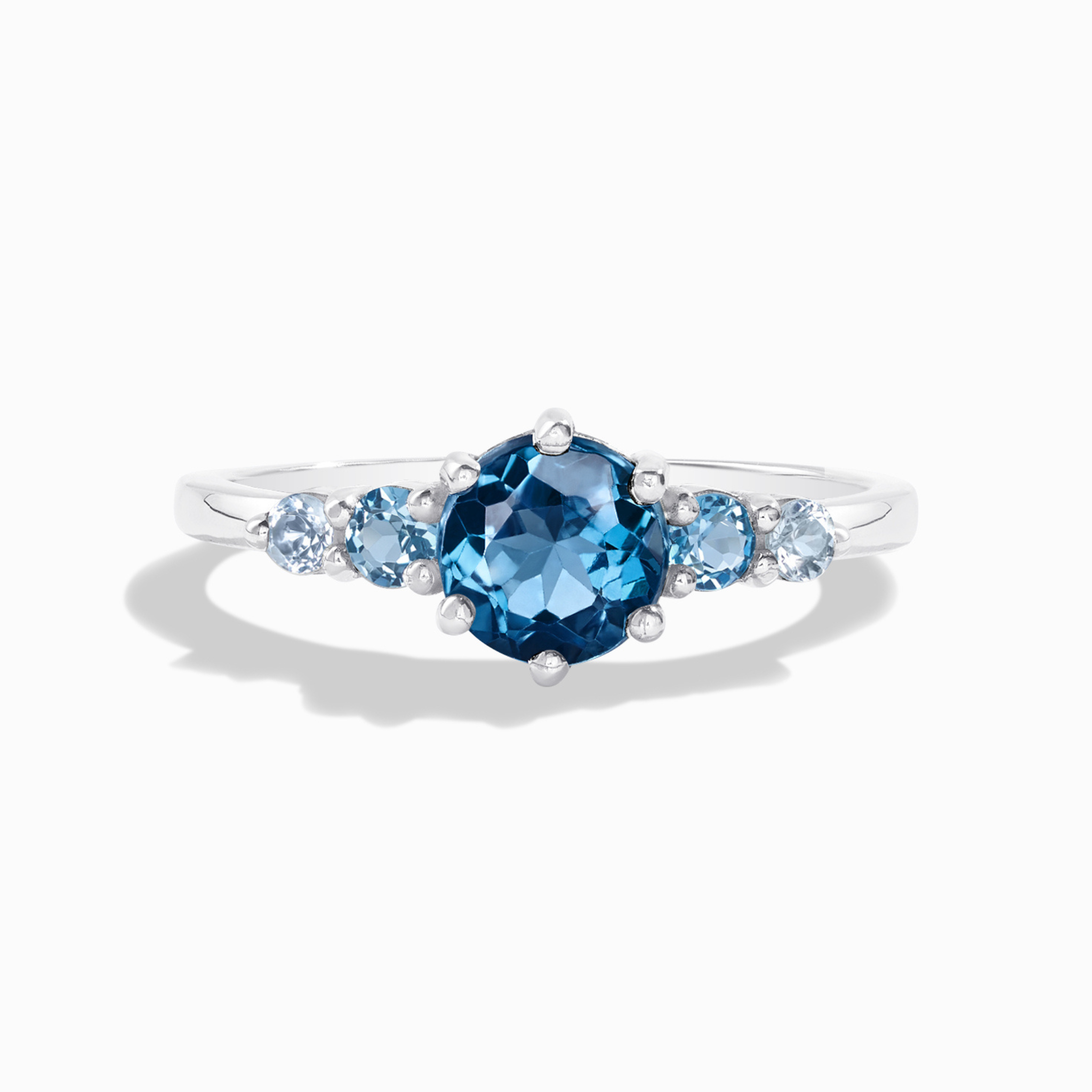 Ombre blue topaz five stone ring in sterling silver on white background
