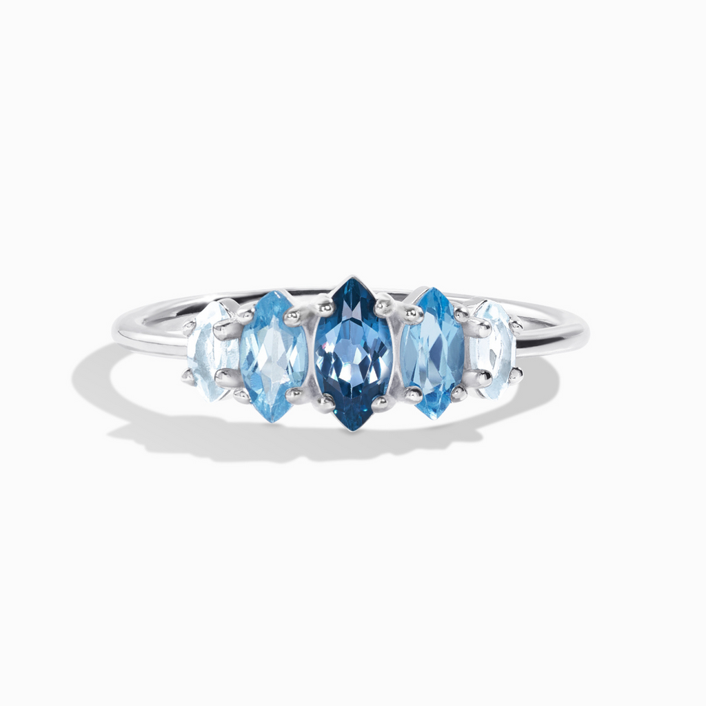 Ombre blue topaz ring in sterling silver on white background