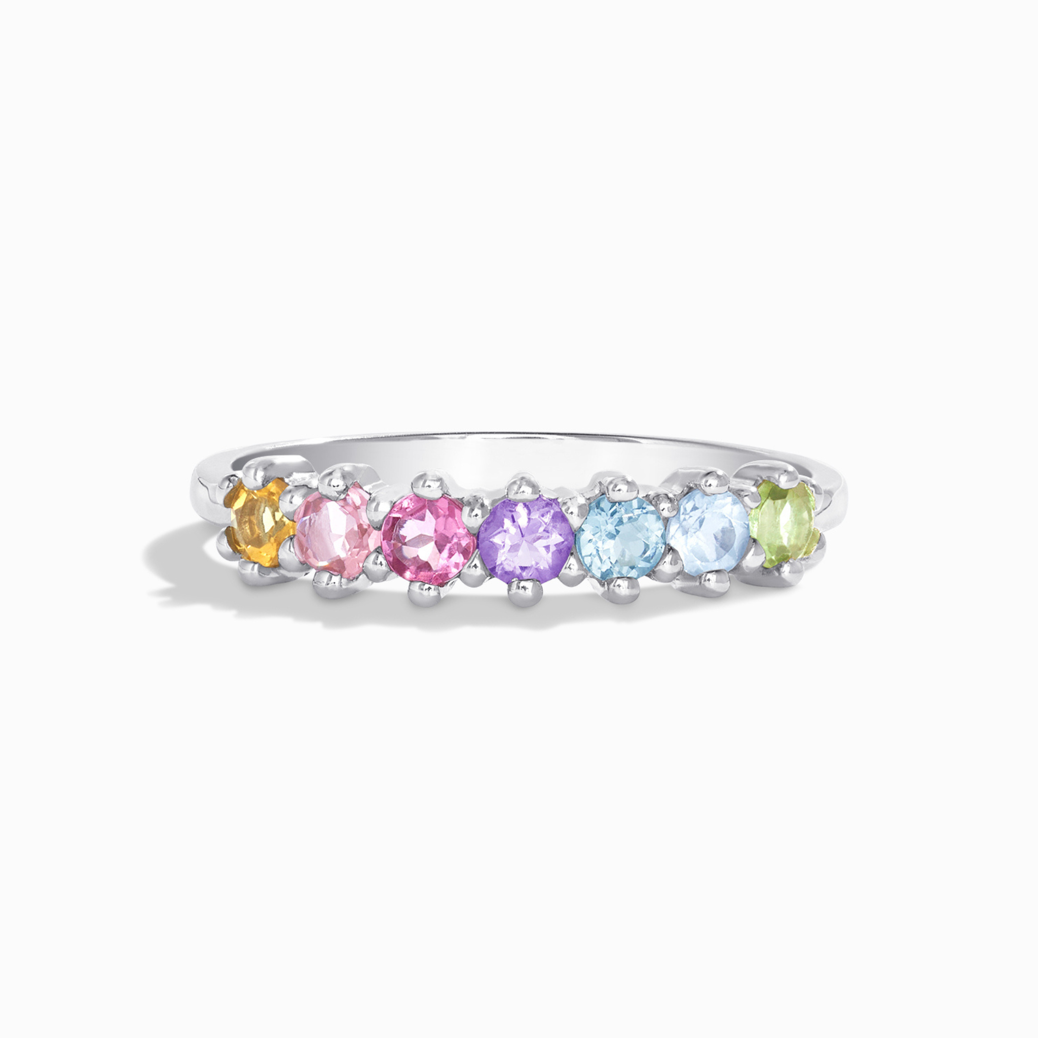 Pastel rainbow gemstone eternity ring in sterling silver on white background