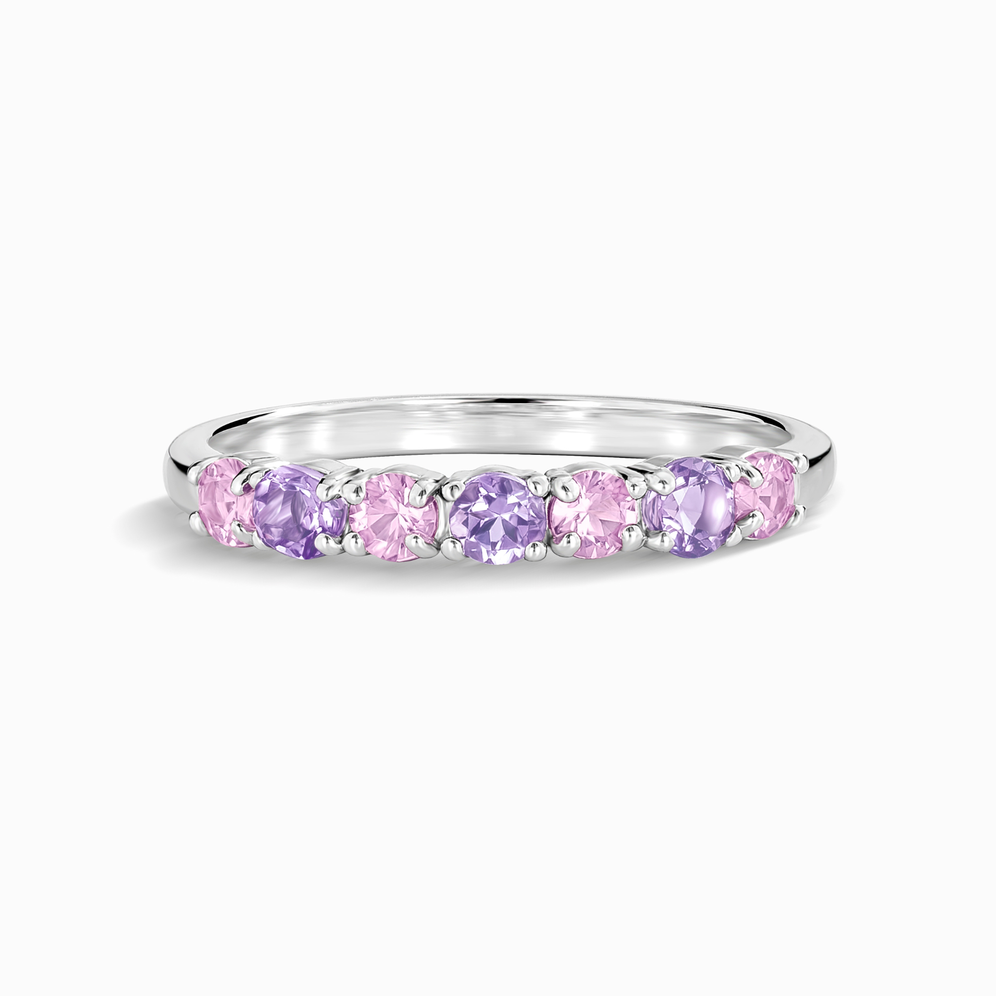 Pink sapphire and pink amethyst half eternity band in sterling silver on white background