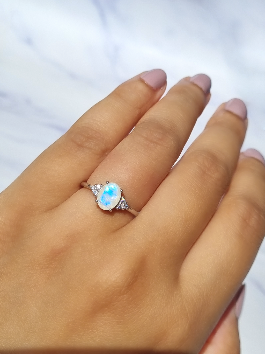 Rainbow moonstone ring in sterling silver on hand