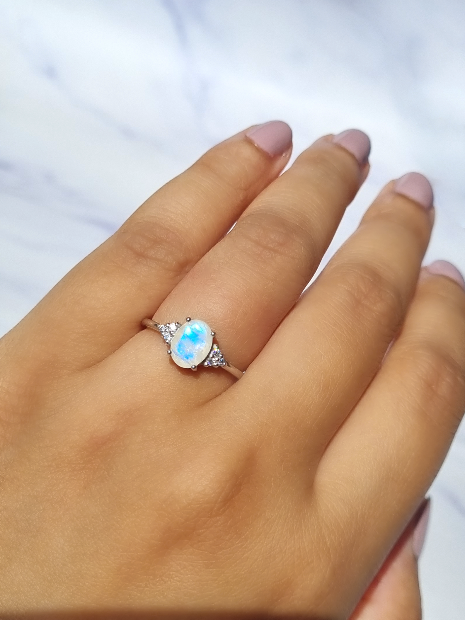 Rainbow moonstone ring in sterling silver on hand
