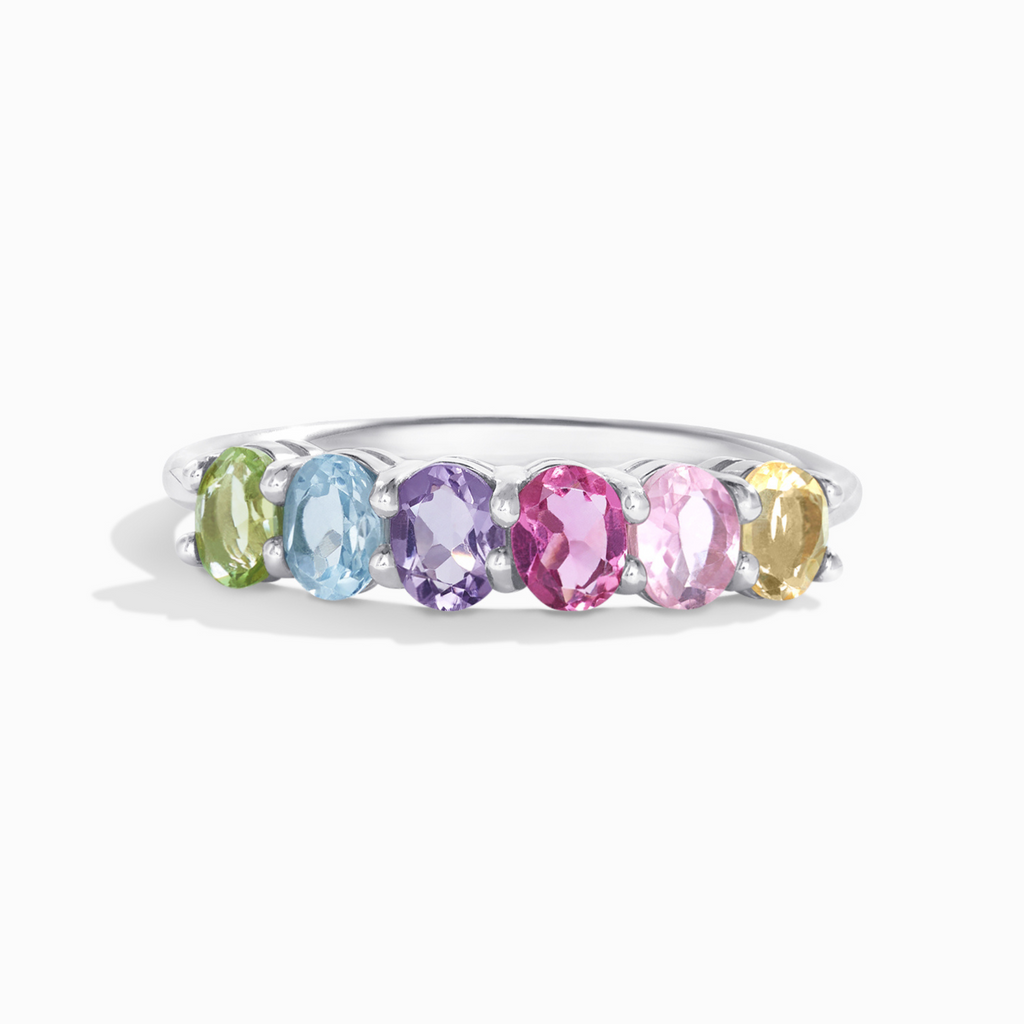 Rainbow multicoloured gemstone half eternity ring in sterling silver on white background